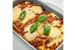 Beef Lasagna - authentic bolognese with bchamel sauce, mozzarella, basil, parmesan